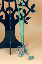 Load image into Gallery viewer, &quot;DAISY&quot; SILVER-PLATED MEDALLION HANGING FROM DOUBLE SILC CORD IN GREEN WITH A PORCELAIN FISH IN ORANGE-GREEN-GOLD
